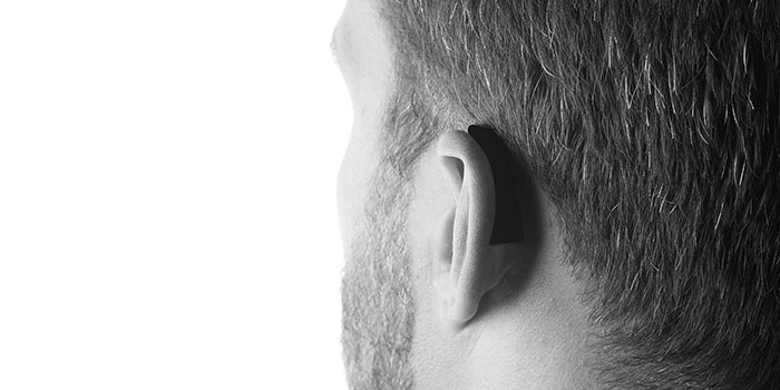 FrenchEar FE1+ Hearing device worn by its founder